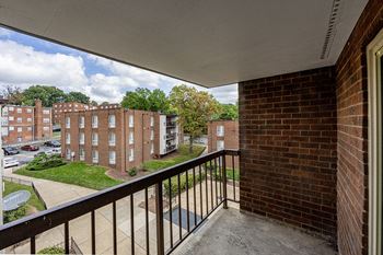 a balcony with a view of a brick building